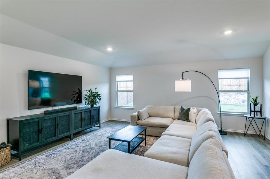 Living room with vaulted ceiling and hardwood / wood-style floors