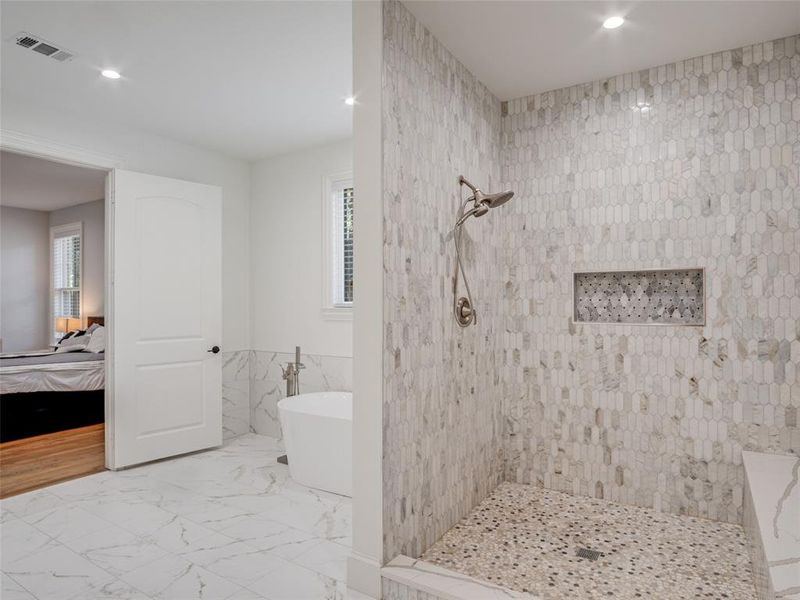 Bathroom featuring tile walls, independent shower and bath, tile patterned floors, and plenty of natural light