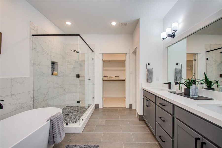 Beautiful Primary Bath with Quartz double sink vanity top and soft close drawers and doors. Model home photos - FINISHES AND LAYOUT MAY VARY!Ceiling fans are NOT INCLUDED!