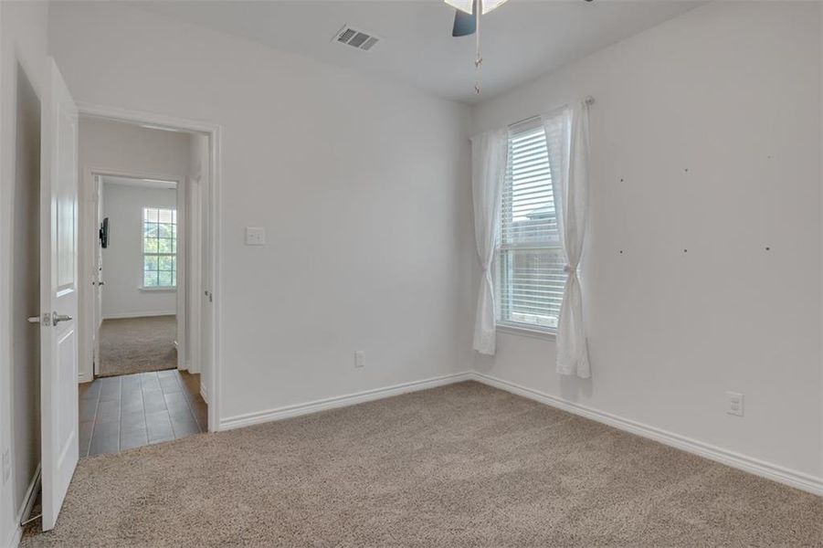 Carpeted spare room with ceiling fan