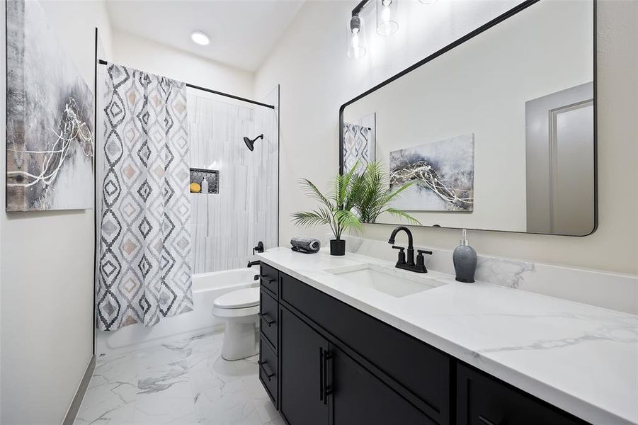 Full bathroom with vanity, toilet, and shower / tub combo with curtain