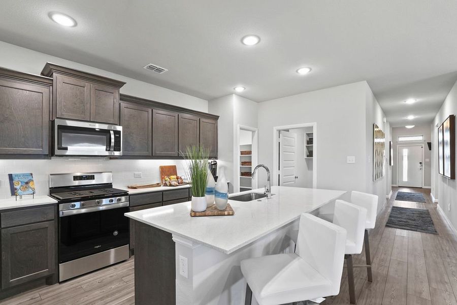 Kitchen in the Oscar home plan by Trophy Signature Homes – REPRESENTATIVE PHOTO