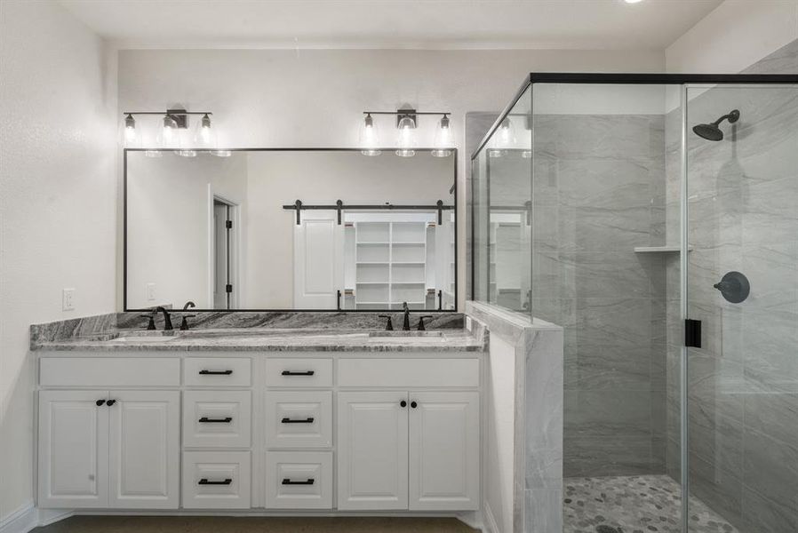 Bathroom featuring vanity and an enclosed shower