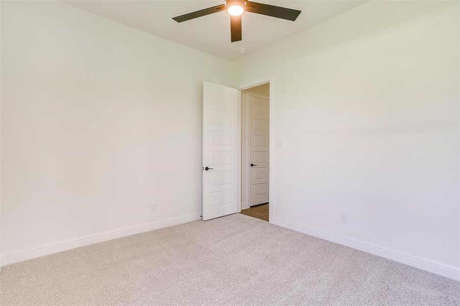 Spare room with carpet flooring and ceiling fan