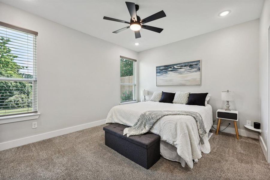 Bedroom featuring multiple windows and carpet floors