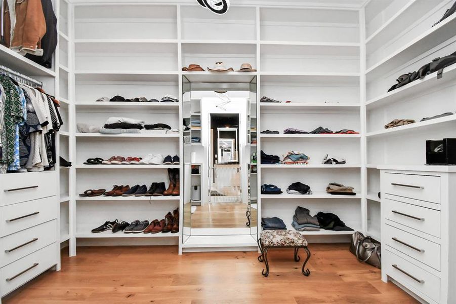 Spacious primary closet with built in shelving.