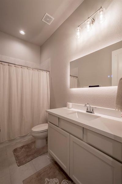 This full secondary bath features a tub/shower combo, Quartz countertop with under mount sink and a 3 color tone LED mirror that will defrost to eliminate wiping the steam off!