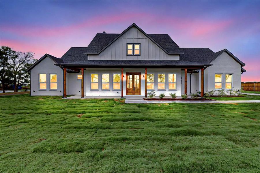 View of front of home featuring a yard and a porch