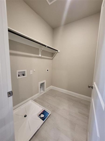 Laundry room with hookup for a gas dryer, hookup for a washing machine, hardwood / wood-style floors, and electric dryer hookup