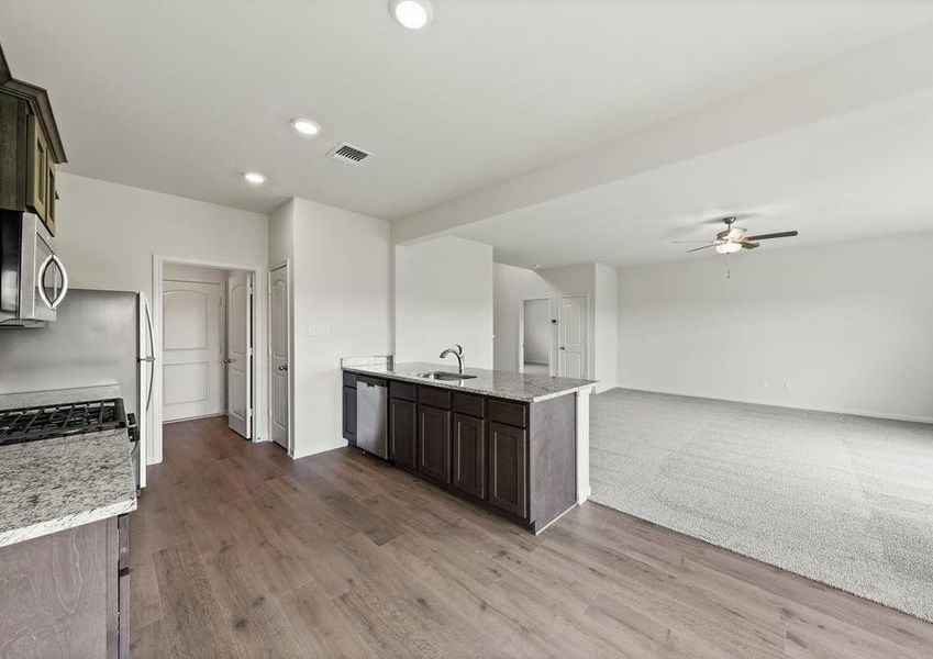 The open layout connects the kitchen with the dining room and family room.