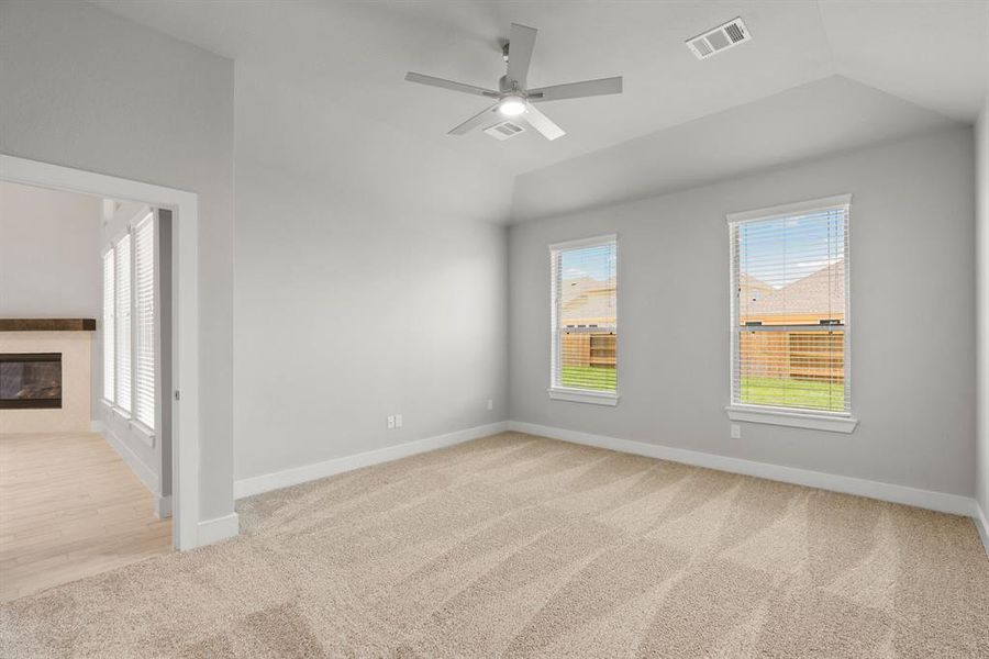 Come decompress in the stunning primary suite after a lengthy day! Experience the luxury of plush carpeting, warm paint hues, high ceilings, and large windows featuring privacy blinds. Sample photo of completed home with similar floor plan. Actual colors and selections may vary.