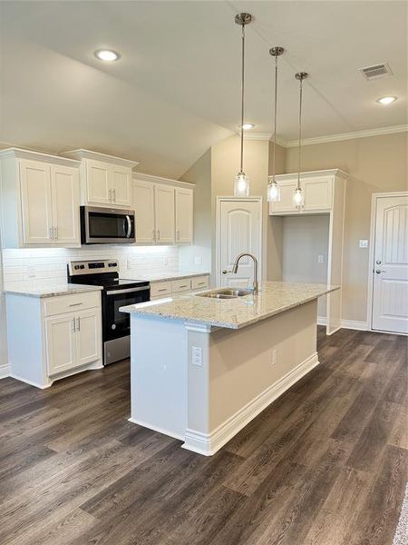 Kitchen featuring range, sink, crown molding, white cabinetry, and dark wood-type flooring