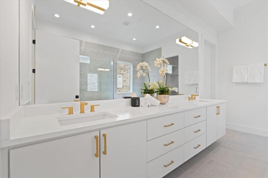 Bathroom featuring tile patterned flooring, vanity, and tiled shower