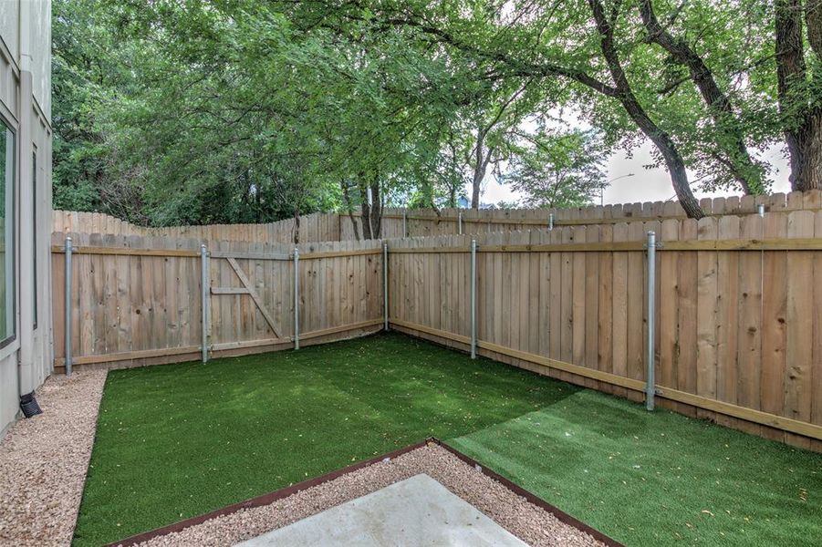 Private yard with gate. This unit has pet friendly turf and the shade trees will be a welcome in Texas weather!