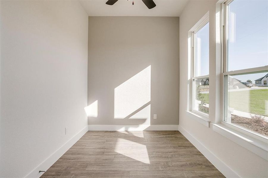 Unfurnished room with light wood-type flooring and ceiling fan