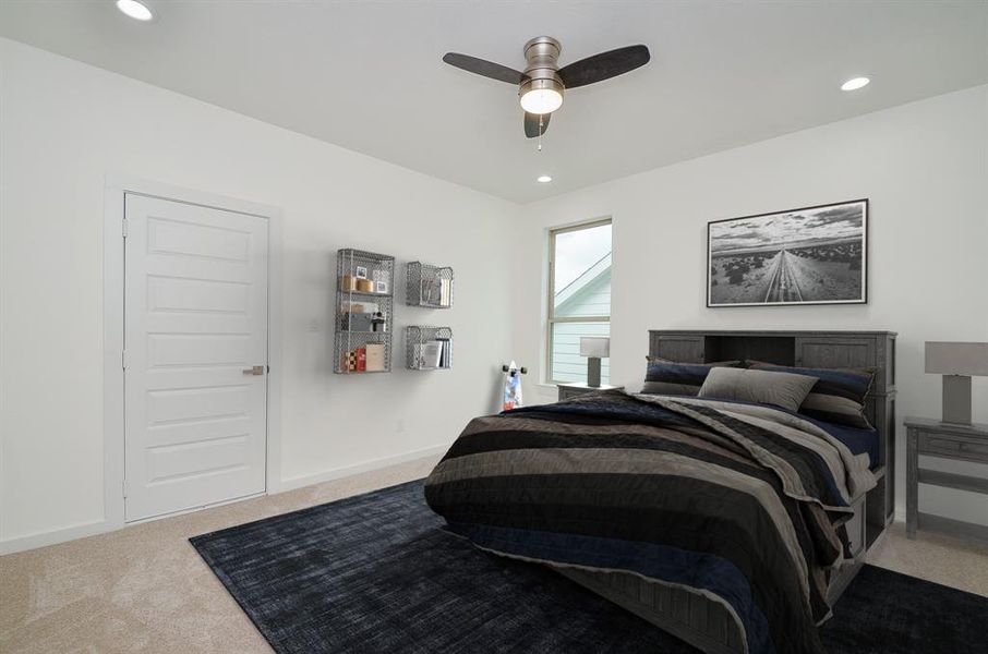 Upstairs secondary bedrooms feature plush carpet, ceiling fans and recessed lighting.