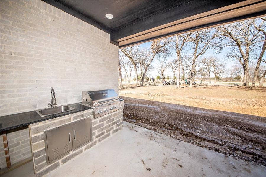 View of terrace with sink, a grill, and an outdoor kitchen