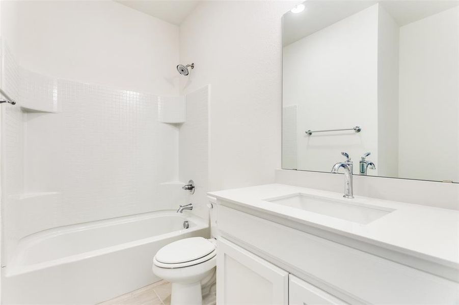 Full bathroom with vanity, tile patterned flooring, shower / bathing tub combination, and toilet