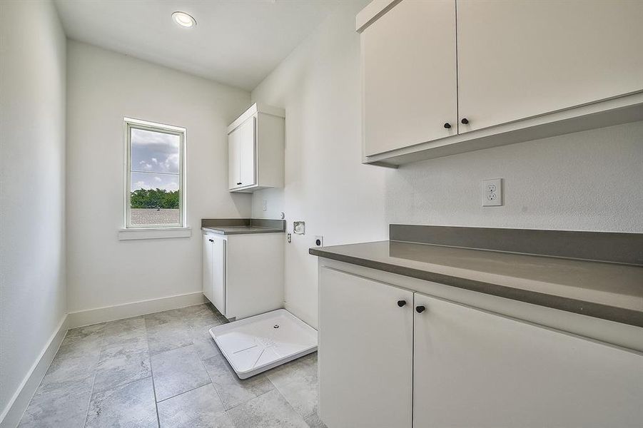 Washroom featuring cabinets and electric dryer hookup