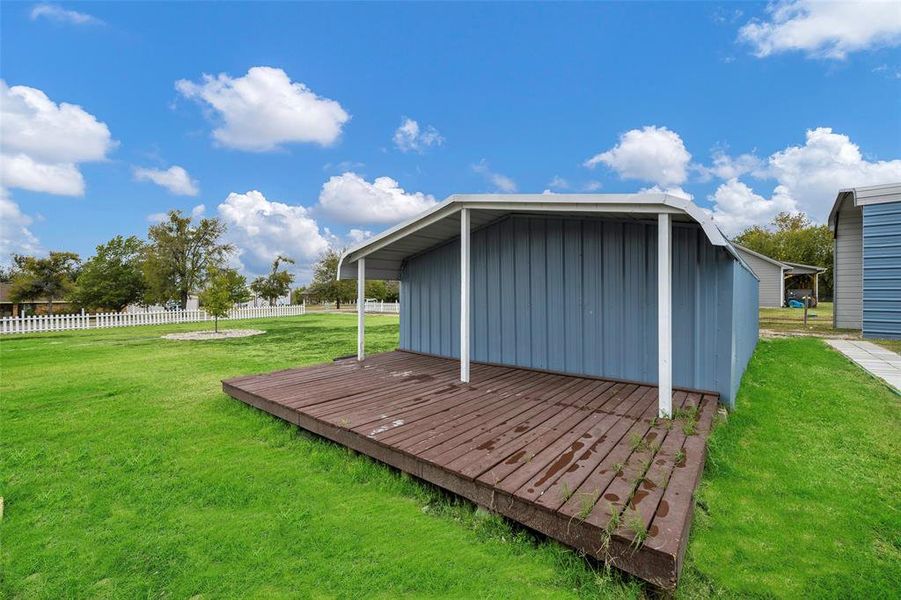 View of outdoor structure with a yard