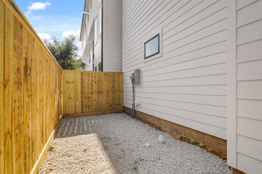 Solid board fencing in the backyard. Plenty of space for a private outdoor hang out.