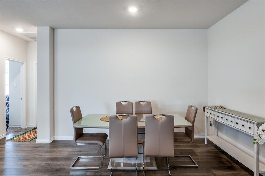 Dining room with dark wood-type flooring