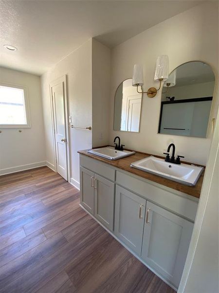 Master Bathroom featuring wood-type flooring and vanity