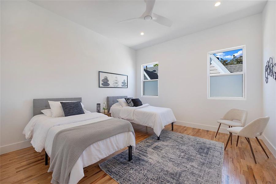 Bedroom with light hardwood / wood-style flooring and ceiling fan