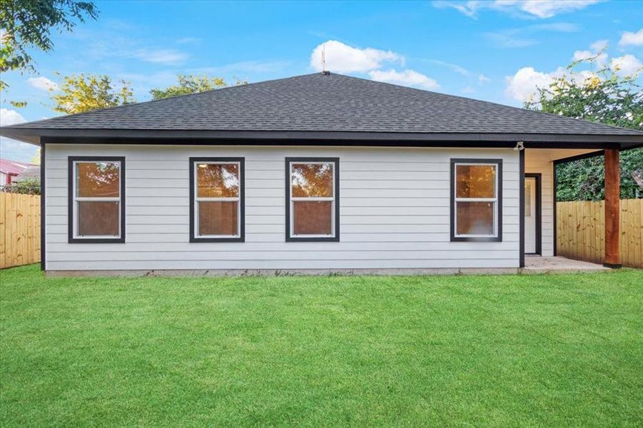 Back of house featuring a lawn