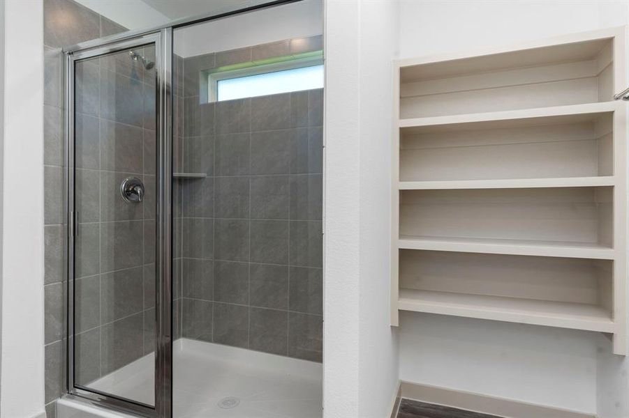 Massive Seamless Glass Shower with Beautiful Tile Surroundings! Transom Window in the Shower that allows that natural light into the Primary Suite Bathroom! **Image Representative of Plan Only and May Vary as Built**