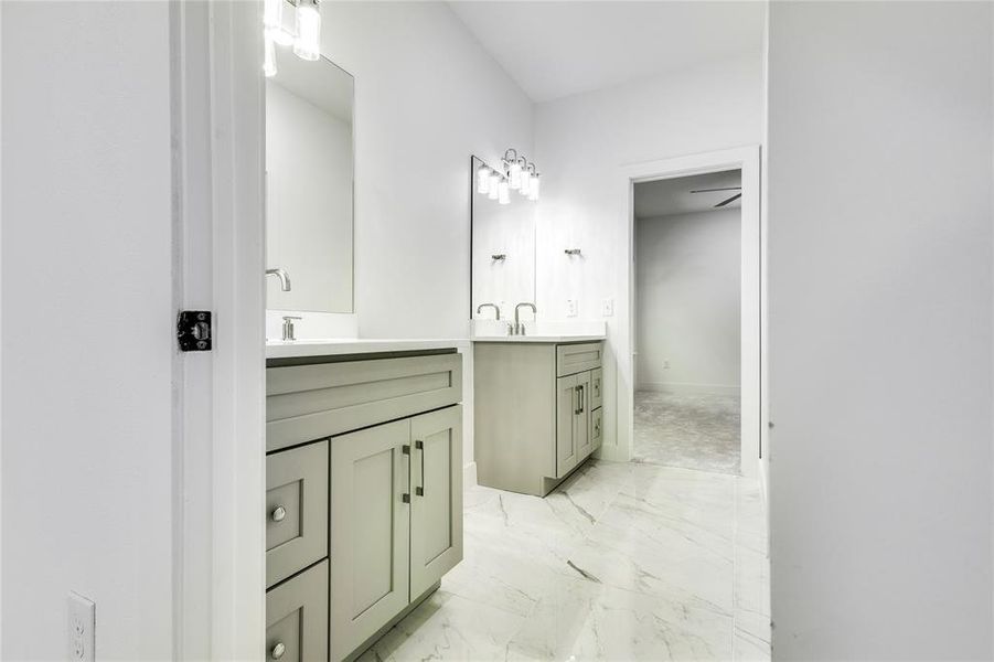 Bathroom with tile floors, vanity, and ceiling fan
