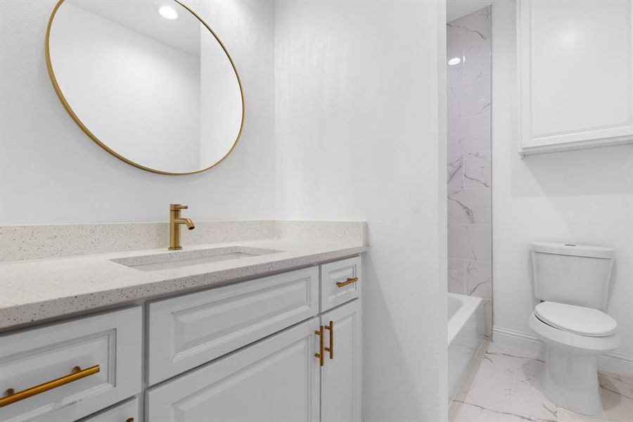 Full bathroom featuring vanity, toilet, and shower / tub combination