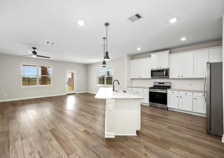 Fully loaded kitchen with beautiful white cabinets.