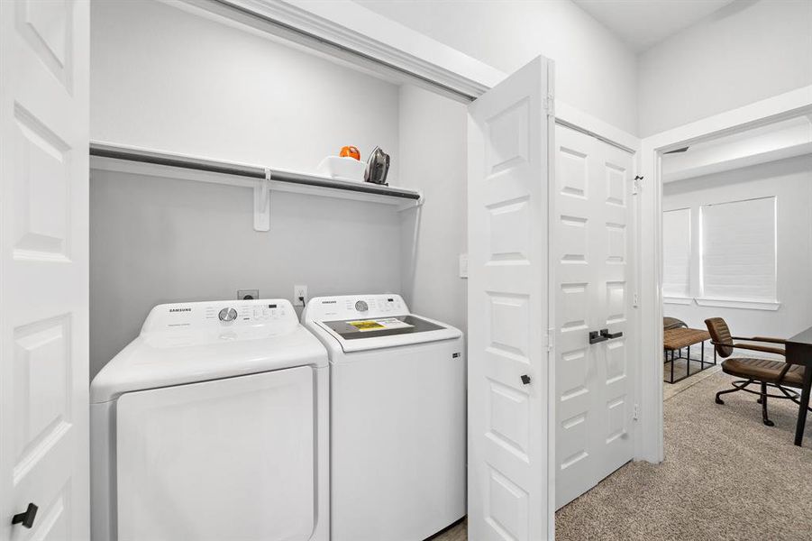 Efficiently designed laundry room with contemporary appliances and ample storage, blending functionality with style.
