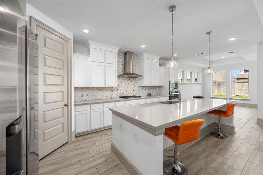 Gourmet kitchen with breakfast bar and oversized island gives this home a luxury feel.