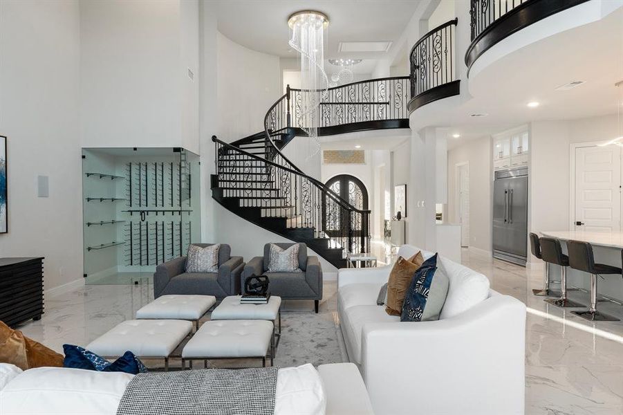 Living room with a high ceiling and a chandelier