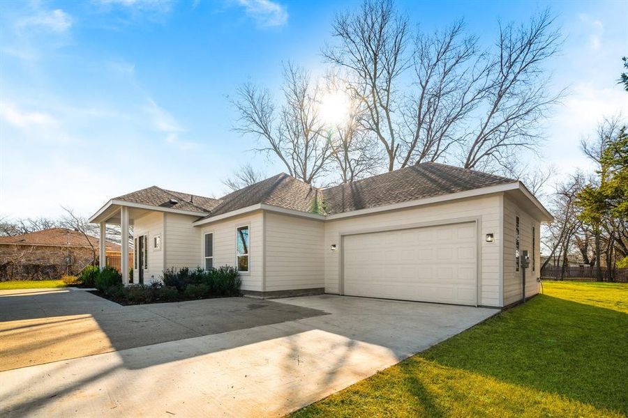 Ranch-style home featuring a garage and a front yard