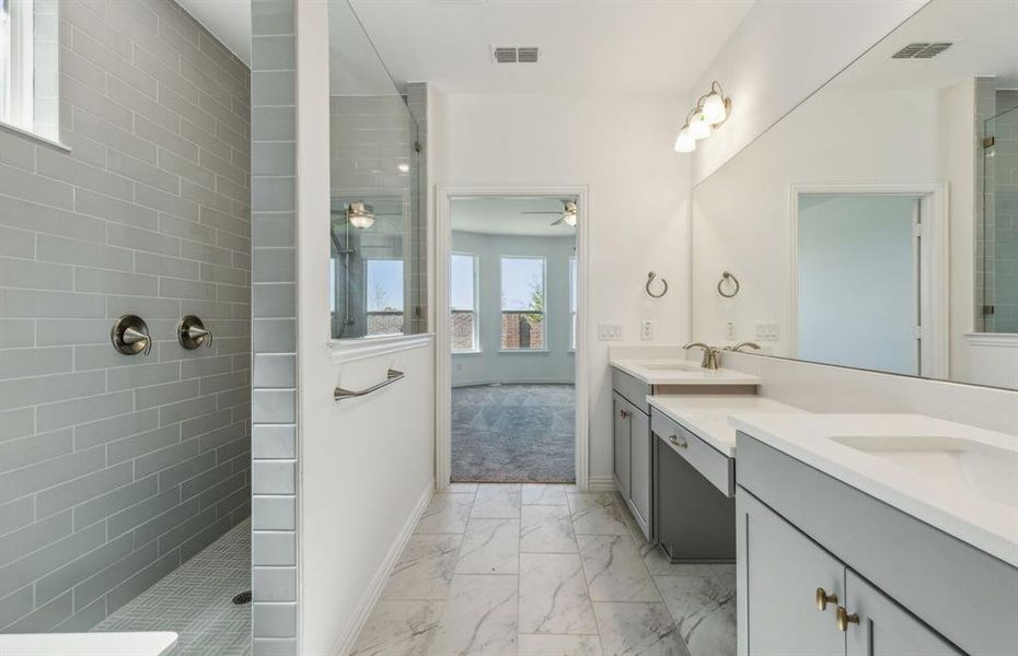 Spacious owner's bathroom with dual vanity *real home pictured