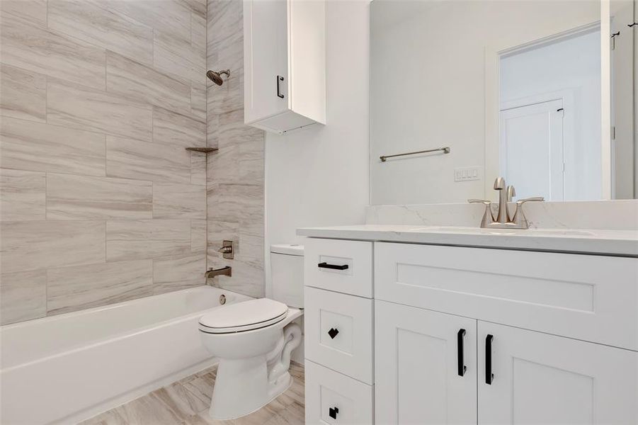 The fourth-floor bathroom features a convenient tub and shower combo, along with a toilet and single sink, offering a well-rounded and functional space.