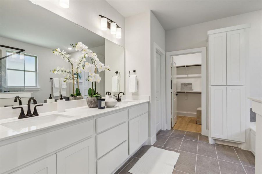 Bathroom featuring tile patterned flooring and vanity