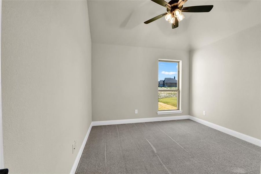 Spare room with carpet floors and ceiling fan