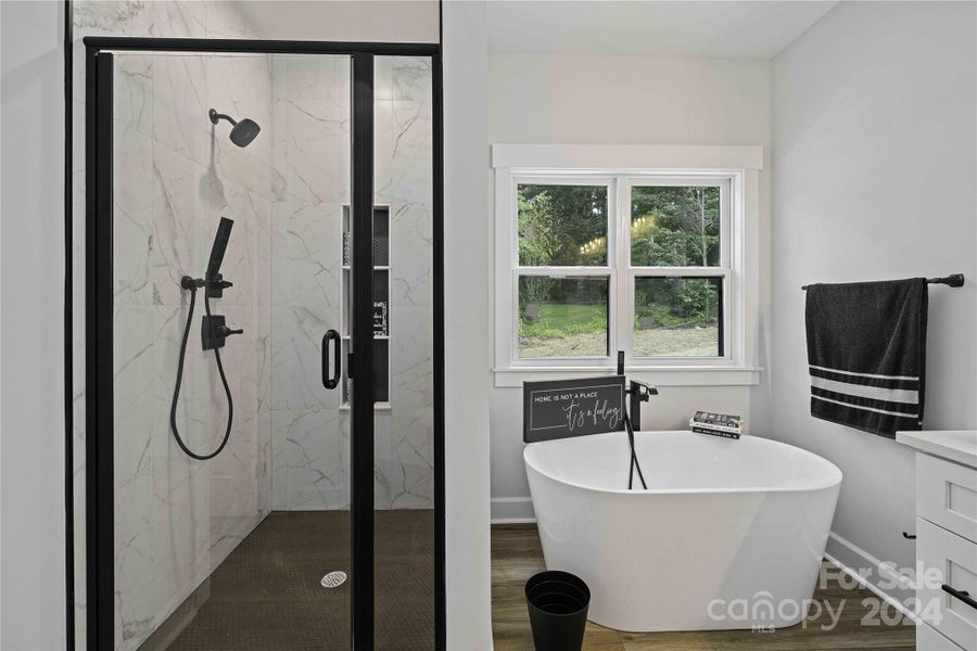Main Bath with Roman Tub & tiled walk in Shower with glass door.