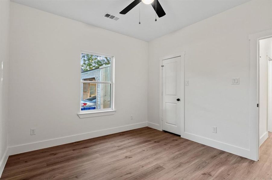 Empty room with light hardwood / wood-style floors and ceiling fan