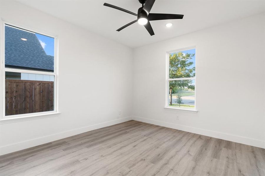 Unfurnished room featuring light wood-type flooring and ceiling fan