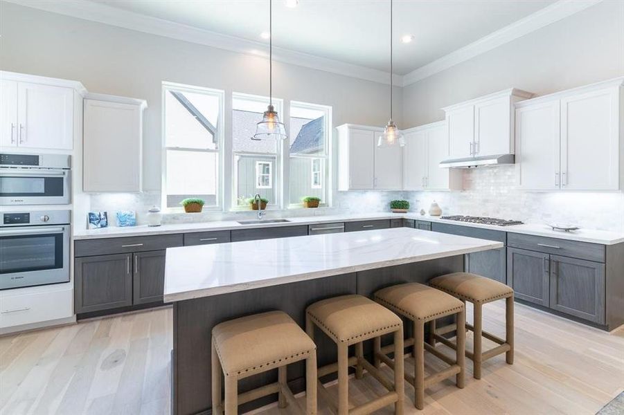 Large island space with tons of cabinets make for easy prep work, entertaining, cooking and a great space to share.