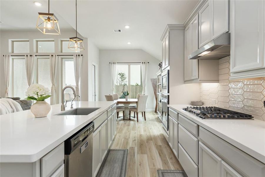 Stainless steel appliances, a gas cooktop, and ample storage make this Kitchen as functional as it is beautiful