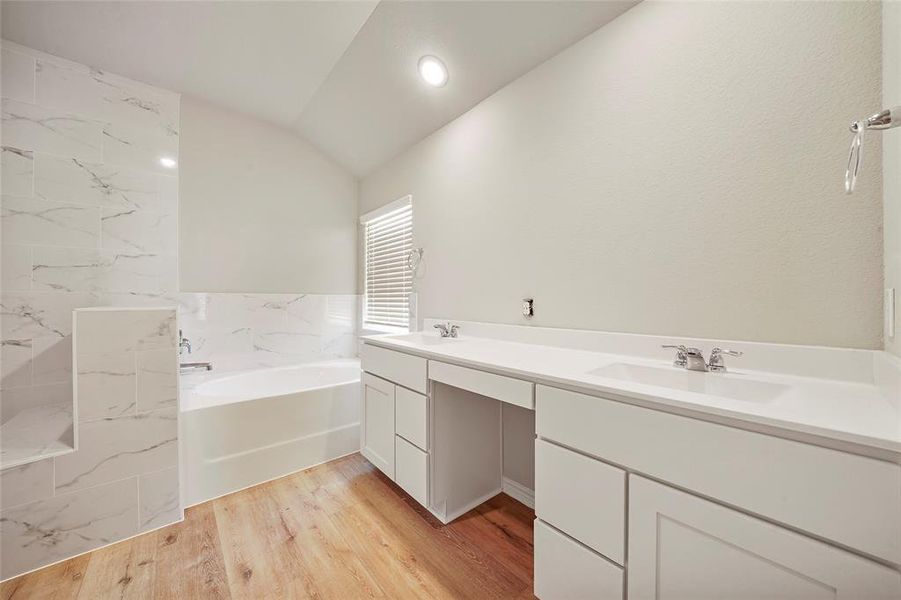 Huge primary bathroom with soaking tub and shower.