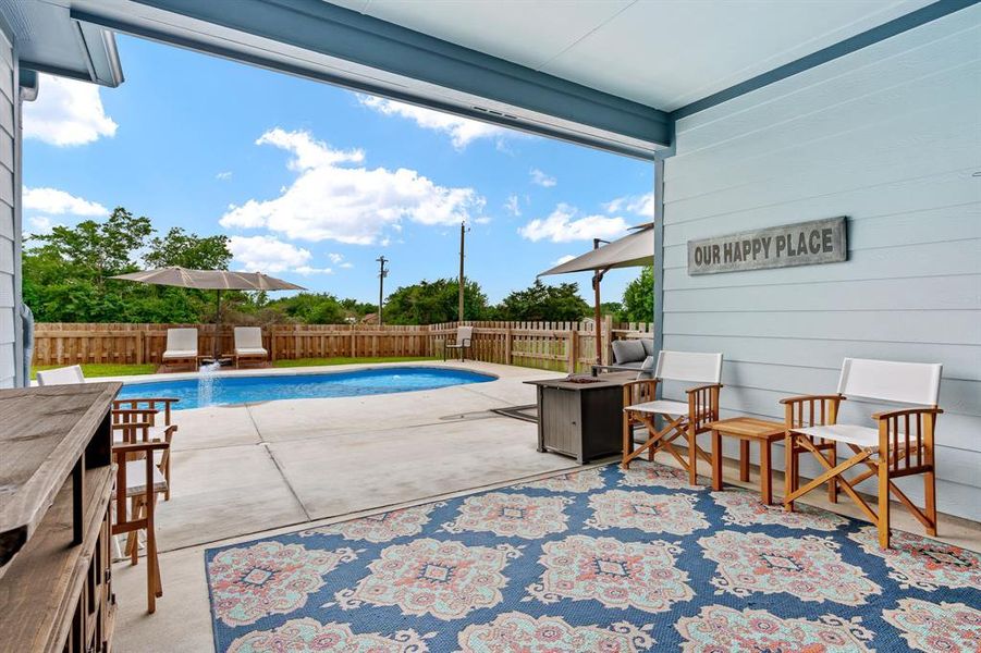 View of swimming pool from large covered side patio.  Perfect for a relaxing day with friends and family.
