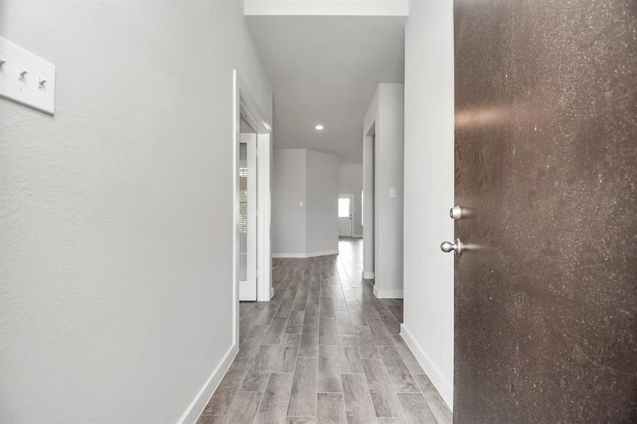 As you step into the threshold of this luxurious home, you'll soon be welcomed by an elegant glass door (to be installed). Inside, soaring ceilings amplify the spaciousness, while the refined wood-look tile flooring and oversized baseboards exude sophistication and charm.