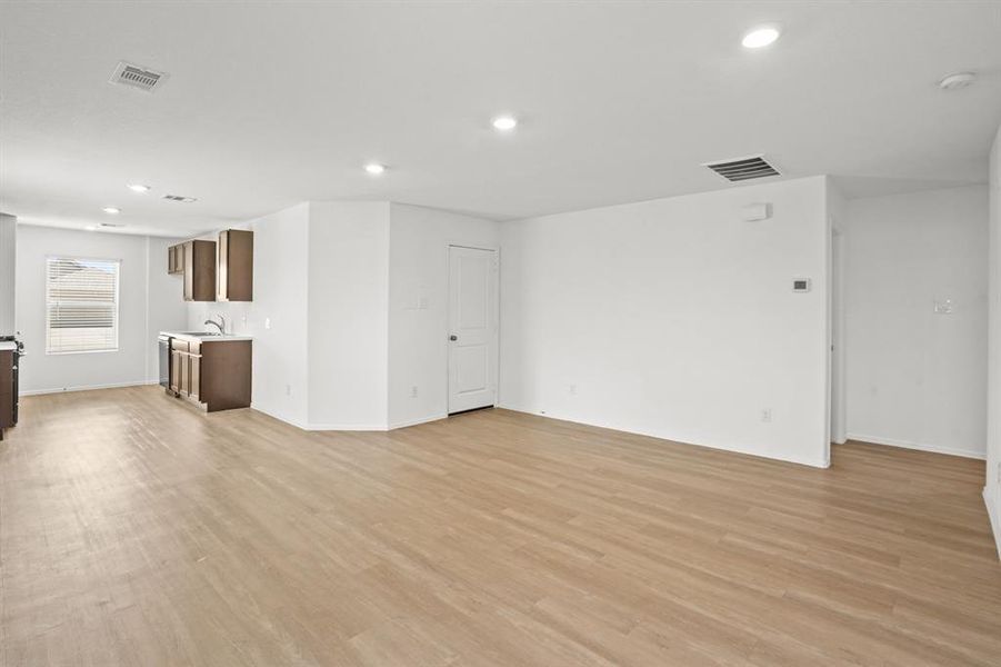 Another view shows just how open concept this kitchen and living room is. So much natural light and space! This light and bright spacious living room is the perfect layout for entertaining or just relaxing!